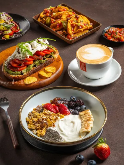 A bright and inviting breakfast spread for Barista. This flatlay showcases a variety of healthy and delicious options, including a fruit and granola bowl, avocado toast, and coffee, creating a fresh, lifestyle feel.