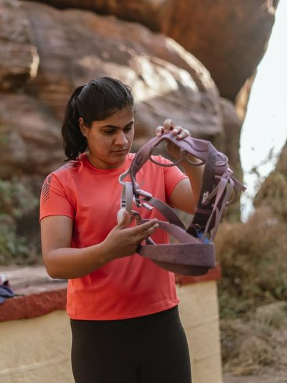 An instructor demonstrating how to inspect and put on a harness. Safety and education are our top priorities.