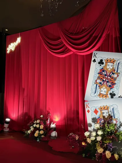 We transformed a milestone birthday into a glamorous Casino Night, where every detail, from the rich red drapes to the custom life-sized playing cards, was designed for an evening of sophisticated fun and high-stakes excitement.