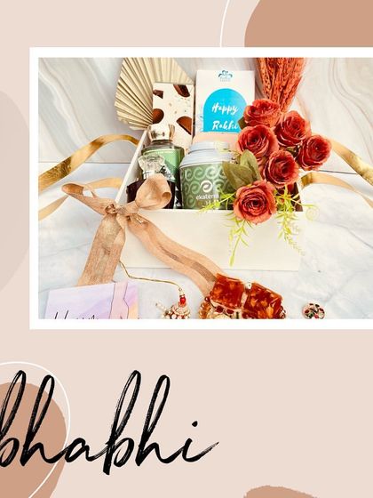 A beautifully composed shot of our Rakhi hamper for Bhaiya and Bhabhi, highlighting the floral arrangement and the thoughtful gifts inside.