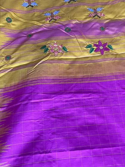 A closer look at the pallu of the Kanjeevaram, where the Kamal Kadai embroidery is most dense. The combination of flowers and whimsical butterflies creates a joyful, celebratory feel.