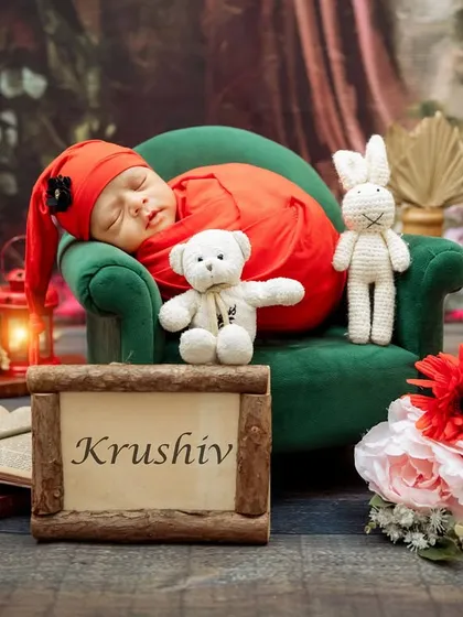 A full view of the red-themed newborn setup, personalized with the baby's name, Krushiv.