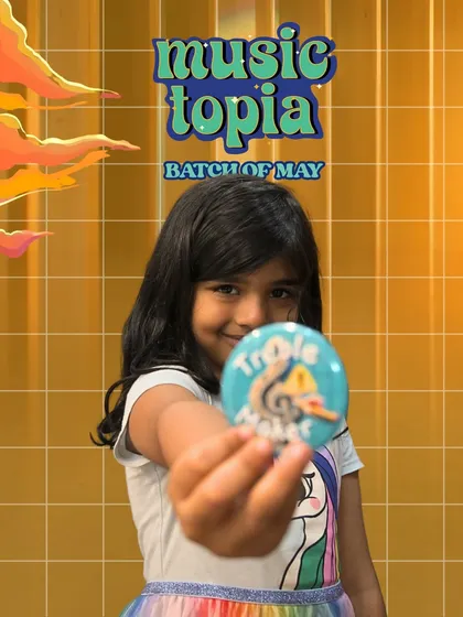 That feeling of accomplishment! Every child leaves Musictopia with a certificate, a progress report, and cool badges to remember their musical journey. This proud smile says it all.