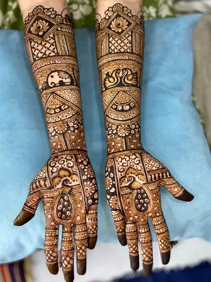 A lovely design featuring a variety of animal motifs, including elephants, swans, and peacocks, all incorporated into a classic bridal pattern.