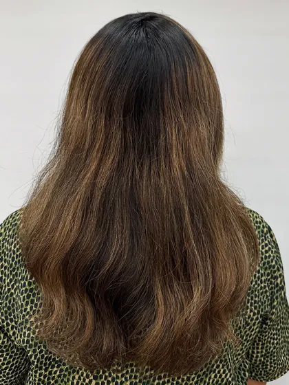 Getting her holiday-ready with a cool ash brown. This color is perfect for neutralizing unwanted warm tones and creating a sleek, modern look.