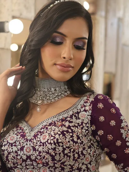 A close-up of the purple glitter eye makeup. This is a great example of a glamorous reception look that is bold yet sophisticated.