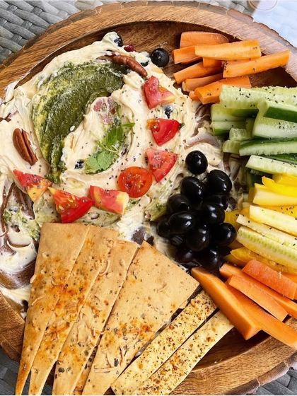 This vibrant platter with a creamy dip, colorful veggie sticks, and healthy crackers is a great way to teach kids that healthy food can be fun and delicious.