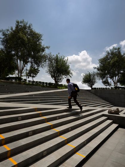 The grand amphitheater-style steps at the Sushant School are a key landscape feature, providing a versatile space for events, classes, or casual seating. The design champions walkability and human interaction, creating a porous and interconnected campus.