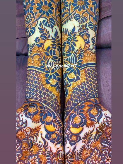 A full-arm bridal design with a unique pattern featuring negative space and bold floral work.