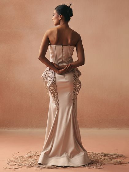 The back view of the Zikaron gown, showing how the cording embroidery traces the corseted bodice and flows down the fish-cut skirt. The design is an ode to bonds stitched into form.