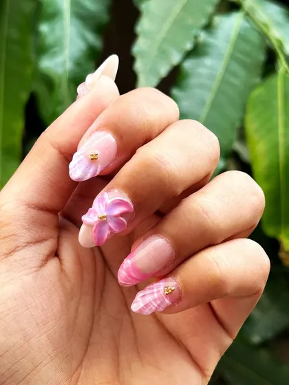 A close-up of the 3D flower nail, showing the delicate, hand-sculpted petals and the texture of the design.