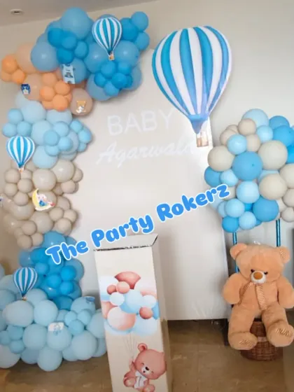 Another view of the hot air balloon welcome baby setup, showing the themed props and the soft, organic balloon clouds.