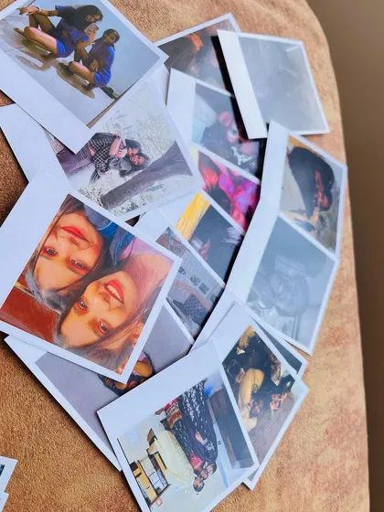 A heart-shaped arrangement of Polaroid prints scattered on a textured surface. This shows just how many memories you can bring to life, perfect for an anniversary or birthday display.