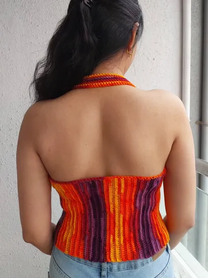 The backless design of the Edith Halter Top is perfect for warm weather and adds a touch of elegance.