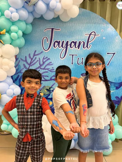 Showing off their cool, temporary sea-creature tattoos that were part of the "Under The Sea" party fun. We love adding little extras to make the theme come alive.