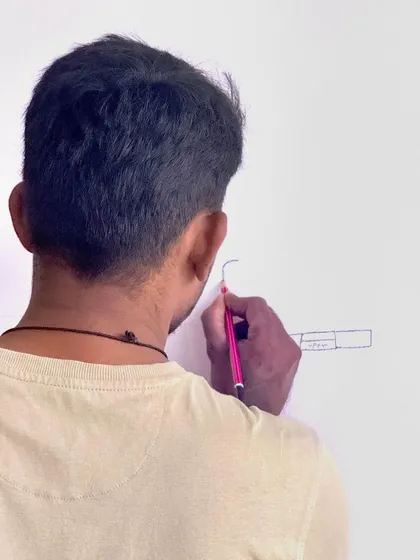 A close-up of the initial design sketch being drawn directly onto the wall. This is where the vision starts to take physical form.