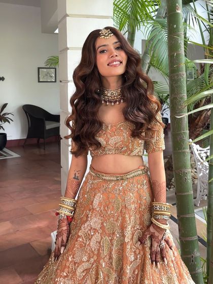 A happy bride showing off her glamorous waves. This style is perfect for brides who want to feel like themselves on their big day.