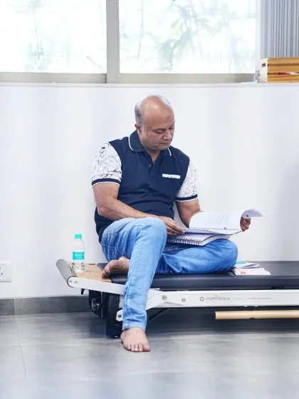 The curriculum is comprehensive. A student reviews the detailed course material covering everything from electrophysiological basics to client consultation protocols.