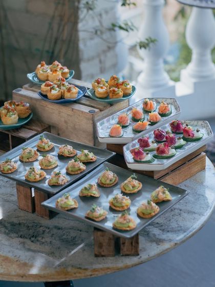 A beautiful spread of appetizers, including sushi and canapés, showcasing the variety we offer for events.