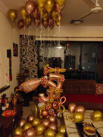 Another view of the 3rd anniversary home decor, showing how the rose gold and gold balloons complement a typical living room space. I ensure the setup fits your home's layout perfectly.