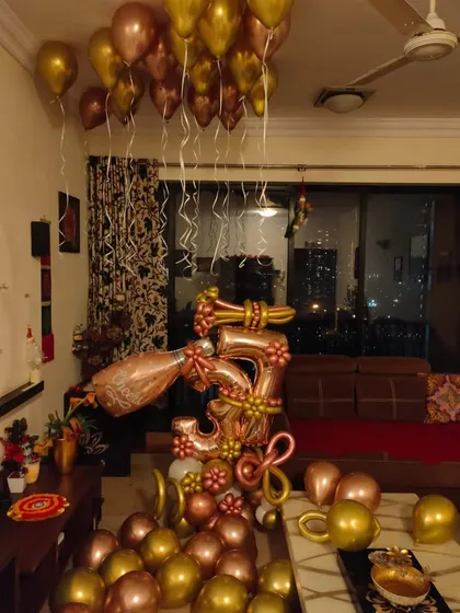 A full view of the living room decorated for a 35th birthday, with a custom bouquet and ceiling balloons.