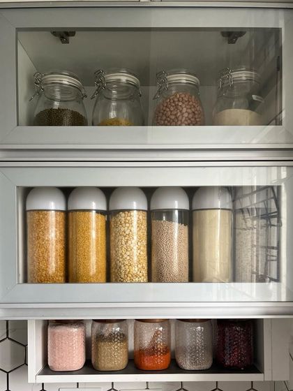 This is my go-to cabinet every morning. Having pulses, spices, and other essentials neatly organized in clear containers makes my daily cooking routine smooth and enjoyable.