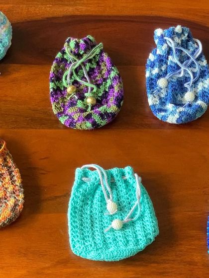 A flat-lay view of the gorgeous potli bags, showcasing the variety of colors and the detailed drawstring closures with bead accents.
