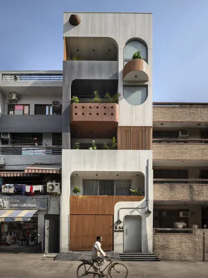 The Slender House, built on a challenging 13-foot-wide plot in Delhi, showcases my approach to compact urban living. The façade's soft curves and material textures create a unique identity, proving that thoughtful design can create expansive experiences within tight constraints.