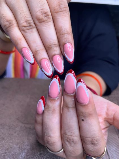 The full set of these unique red and white French tip nails, showing how the design comes together.
