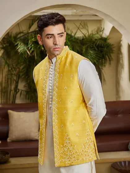 A closer view of the yellow jacket, highlighting the intricate threadwork along the placket and hem. It's these details that elevate a simple outfit.
