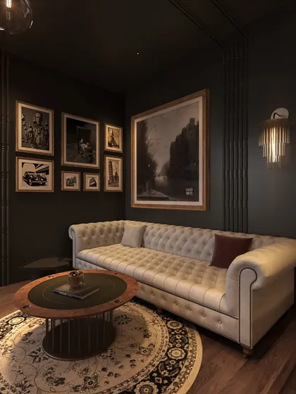 A gallery wall of black and white photographs adds a personal and classic touch to the moody lounge, set against the near-black walls.