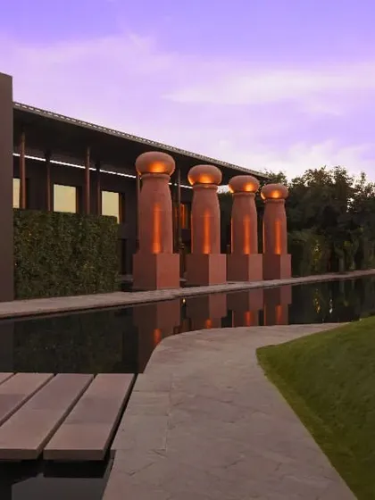 The resort at twilight, with its blend of modern architecture and natural landscapes. It is an ideal setting for quiet evening get-togethers or a peaceful stroll.