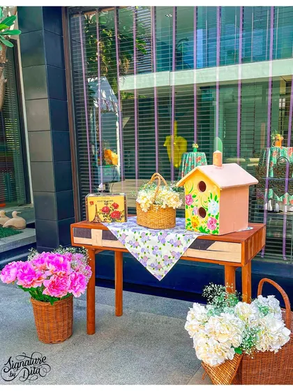 Another decorative vignette from the Fairyland party, featuring floral arrangements and a charming birdhouse. These details help build a cohesive and magical atmosphere throughout the event space.
