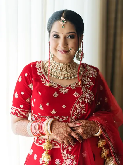 A close-up portrait of the bride, her smile radiating happiness. This shot focuses on her beautiful makeup, jewelry, and the joy in her eyes.