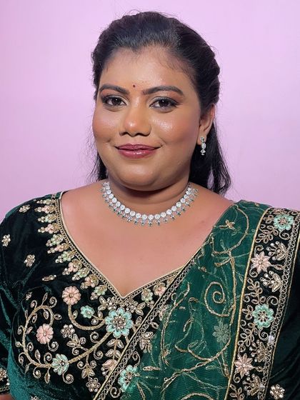 A smiling portrait of Geetha, looking confident and ready for her event. My aim is to empower clients and students with the confidence that comes from professional makeup.