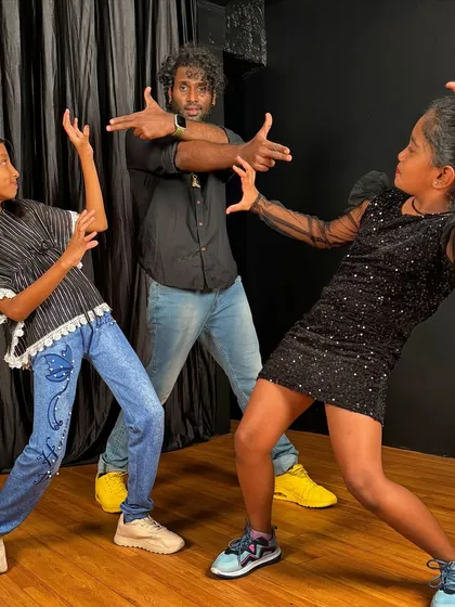 Striking a powerful pose with two of my students after a shoot. This shows the fun, collaborative relationship I have with my dancers.