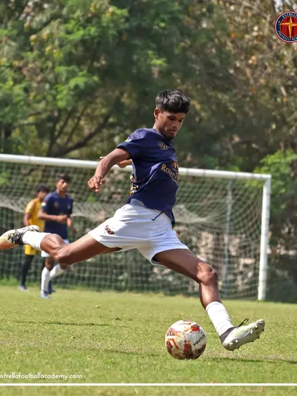 A player strikes the ball with perfect form during a Football Delhi A Division league match, showcasing advanced shooting technique.