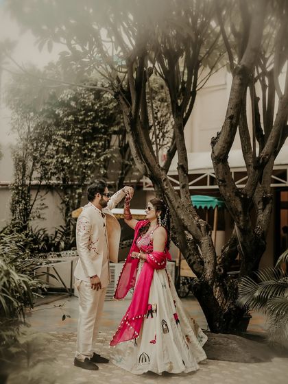 A dance in the garden. This shot captures the graceful movement and connection between the couple during their Haldi celebration, with the bride's vibrant pink lehenga adding a beautiful pop of color.