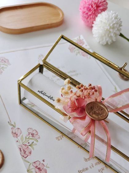 Another view of the boxed wedding invitation, highlighting the delicate details of the packaging. Every element is chosen to create a beautiful and cohesive presentation.