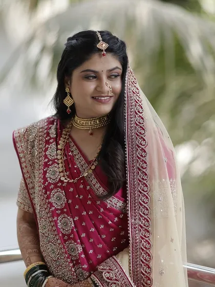 A candid and happy bride. The makeup enhances her natural beauty, making her look radiant and joyful.