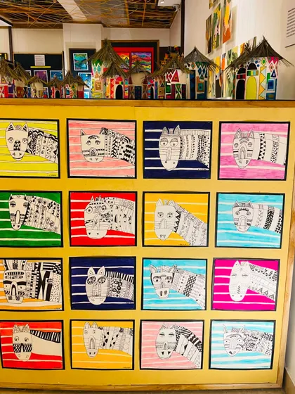 This display showcases zebra drawings inspired by African art, where students aged 8 to 12 explored bold patterns and contrasting colors.