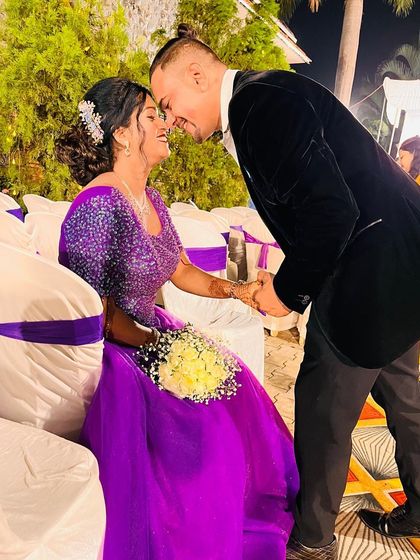 A Cinderella moment for this happy couple. The bride-to-be shines in a vibrant purple ball gown during her engagement celebration.