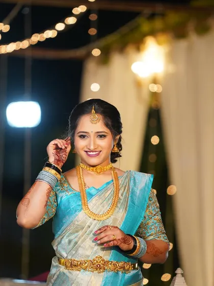 The bride's smile shines as bright as the festive lights behind her.