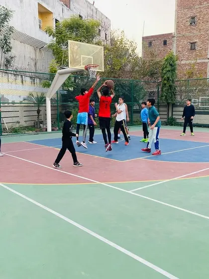 A player goes up for a rebound, showing the athleticism we build.
