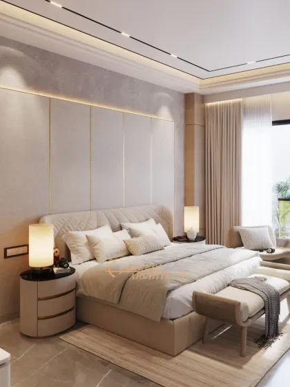 A luxurious bedroom retreat featuring a quilted headboard and a full-height upholstered wall panel with brass inlays. The neutral tones and soft lighting create a timeless and tranquil atmosphere.