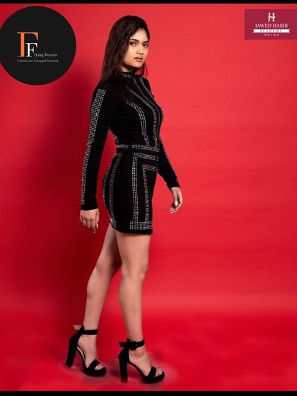 A full-length shot of the model, showing how our students' work contributes to a complete, polished fashion look.