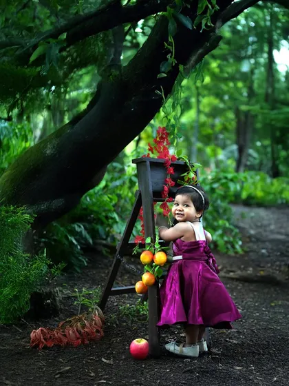 Outdoor shoots are like stepping into a fairy tale. Using the beauty of nature as our backdrop, I create enchanting portraits like this one of a little princess in a magical forest setting.