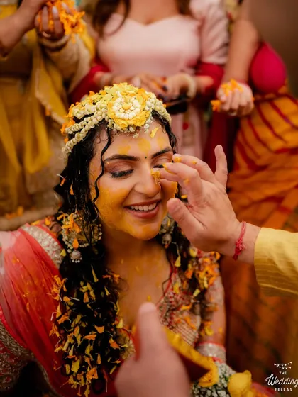 The quintessential Haldi shot. Even while being covered in turmeric, her glowing skin and bright smile shine through.