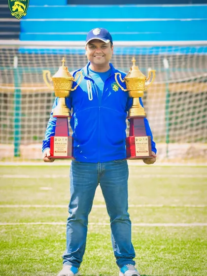 One of our head coaches proudly displaying the championship trophies. Our leadership team is composed of experienced players who understand what it takes to win.