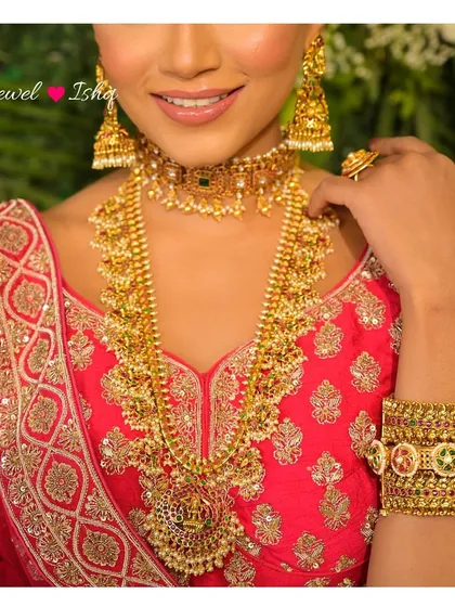Embracing tradition with our exquisite temple jewellery collection. This layered gold set, featuring a choker and a long haram necklace, is rich in heritage and perfect for the main wedding ceremony. Each piece tells a story of divine craftsmanship.